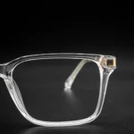transparent square eyeglass frame with gold hinge detail